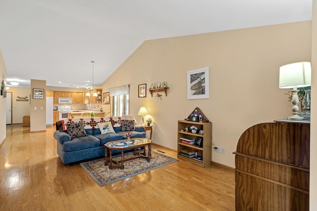 553 Cedar Ct, Taylors Falls, MN 55084 - living area with baseboards, lofted ceiling, and light wood-type flooring