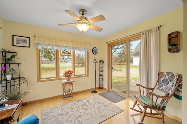 553 Cedar Ct, Taylors Falls, MN 55084 - living area featuring light wood-style floors, a ceiling fan, and baseboards