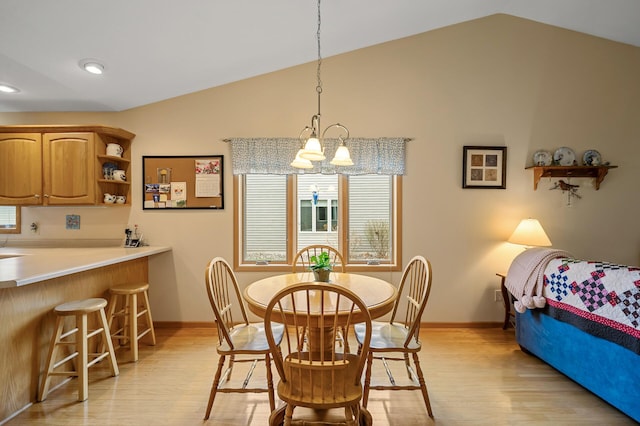 553 Cedar Ct, Taylors Falls, MN 55084 - dining room featuring lofted ceiling, a chandelier, light wood-style floors, and baseboards