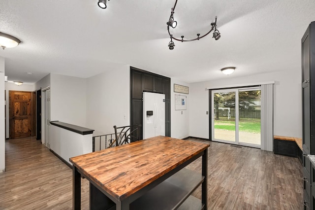 dining room with a textured ceiling and light wood-style flooring