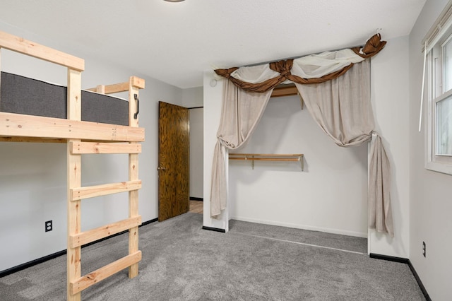 unfurnished bedroom featuring baseboards and carpet