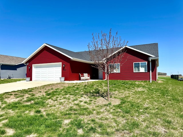 ranch-style home with an attached garage, concrete driveway, and a front yard
