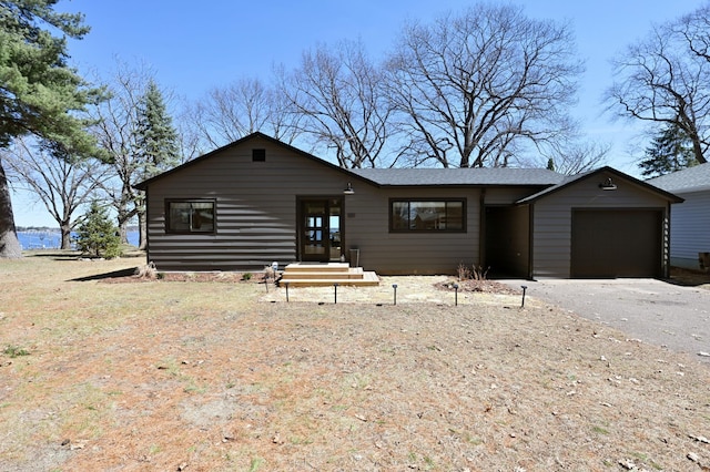 1011 Burgs Park Dr, Shell Lake, WI 54871 - ranch-style house featuring a shingled roof, driveway, and a garage
