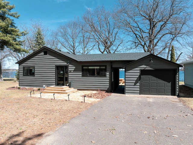 1011 Burgs Park Dr, Shell Lake, WI 54871 - view of front of property with an attached garage, a shingled roof, and driveway