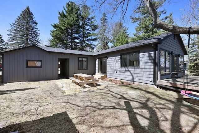 1011 Burgs Park Dr, Shell Lake, WI 54871 - view of front of home with board and batten siding, a patio, and a deck