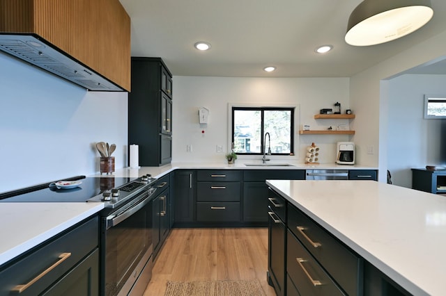 1011 Burgs Park Dr, Shell Lake, WI 54871 - kitchen featuring stainless steel dishwasher, a sink, light countertops, electric range oven, and light wood-style flooring