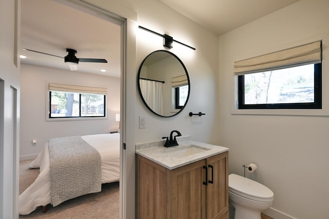 1011 Burgs Park Dr, Shell Lake, WI 54871 - bathroom with toilet, a ceiling fan, vanity, and baseboards