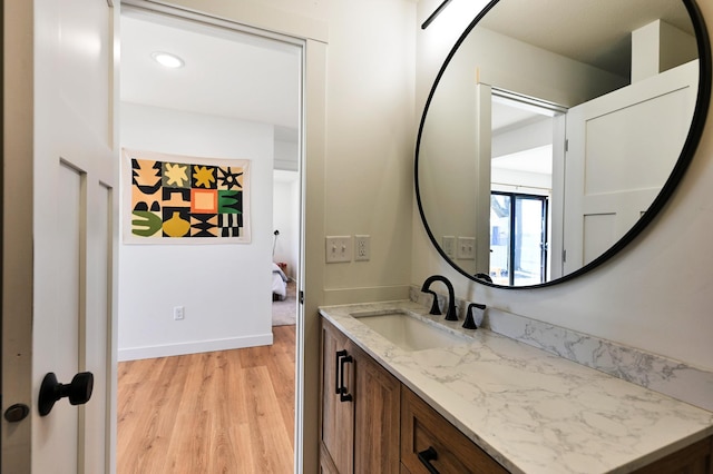 1011 Burgs Park Dr, Shell Lake, WI 54871 - bathroom featuring baseboards, wood finished floors, and vanity