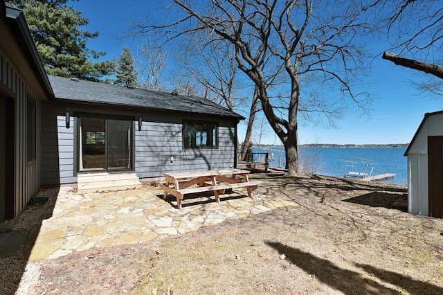 1011 Burgs Park Dr, Shell Lake, WI 54871 - view of yard featuring a water view, a patio, and entry steps