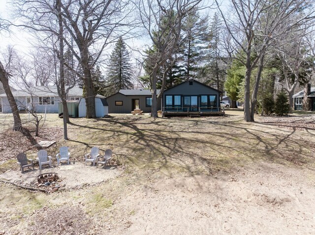 1011 Burgs Park Dr, Shell Lake, WI 54871 - exterior space featuring a fire pit and a sunroom