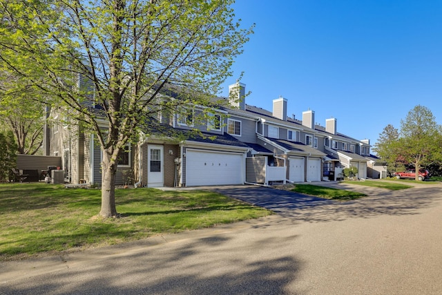 8397 Corcoran Cir Unit 26, Inver Grove Heights, MN 55076 - multi unit property featuring asphalt driveway, a garage, a chimney, a front lawn, and a residential view