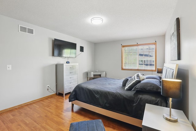 8397 Corcoran Cir Unit 26, Inver Grove Heights, MN 55076 - bedroom featuring a textured ceiling, wood finished floors, and baseboards