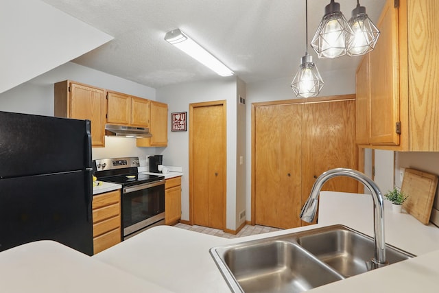 8397 Corcoran Cir Unit 26, Inver Grove Heights, MN 55076 - kitchen with freestanding refrigerator, stainless steel range with electric cooktop, under cabinet range hood, light countertops, and hanging light fixtures