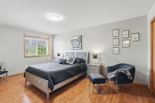 8397 Corcoran Cir Unit 26, Inver Grove Heights, MN 55076 - bedroom featuring wood finished floors and a textured ceiling