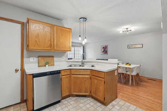 8397 Corcoran Cir Unit 26, Inver Grove Heights, MN 55076 - kitchen featuring dishwasher, a peninsula, light countertops, light floors, and a textured ceiling