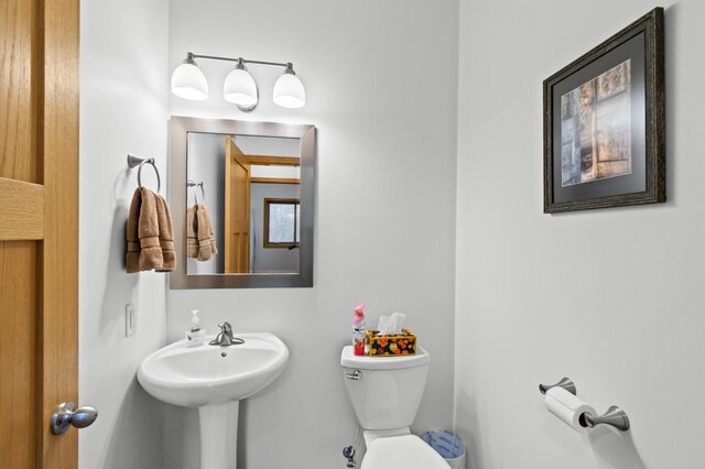 bathroom with toilet and a sink