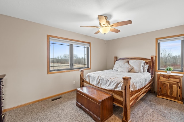 bedroom featuring visible vents, ceiling fan, light colored carpet, and baseboards