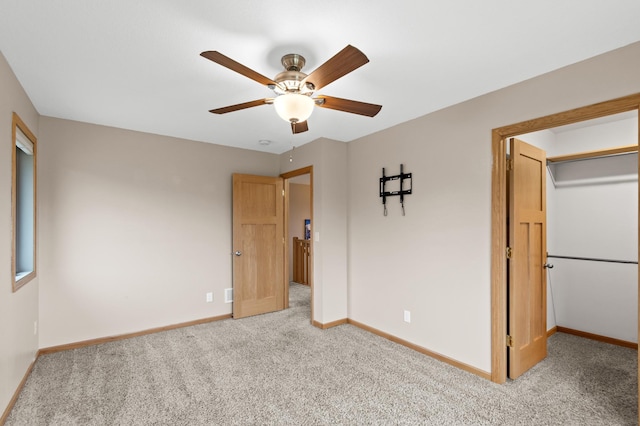 unfurnished bedroom featuring baseboards, ceiling fan, and light colored carpet