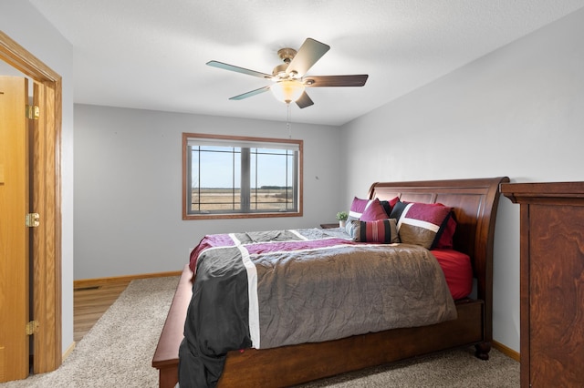 bedroom with a ceiling fan and baseboards