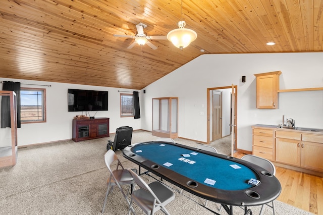 recreation room featuring baseboards, vaulted ceiling, a ceiling fan, and wood ceiling