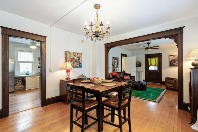 3304 Longfellow Ave, Minneapolis, MN 55407 - dining space featuring baseboards, light wood-type flooring, and ceiling fan with notable chandelier