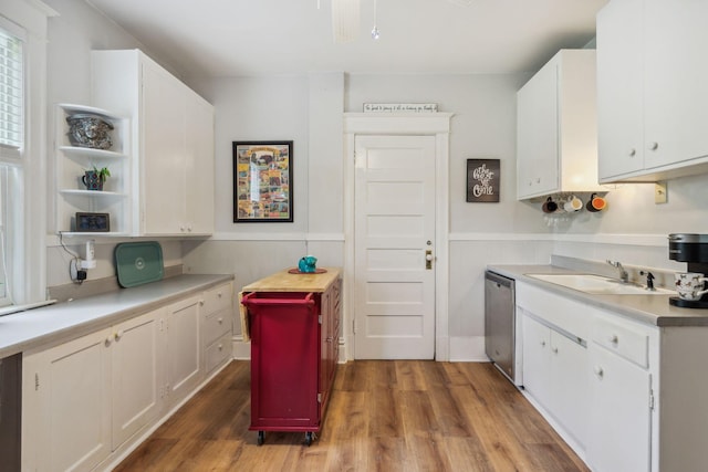 3304 Longfellow Ave, Minneapolis, MN 55407 - kitchen featuring a sink, light countertops, a wainscoted wall, dishwasher, and wood finished floors