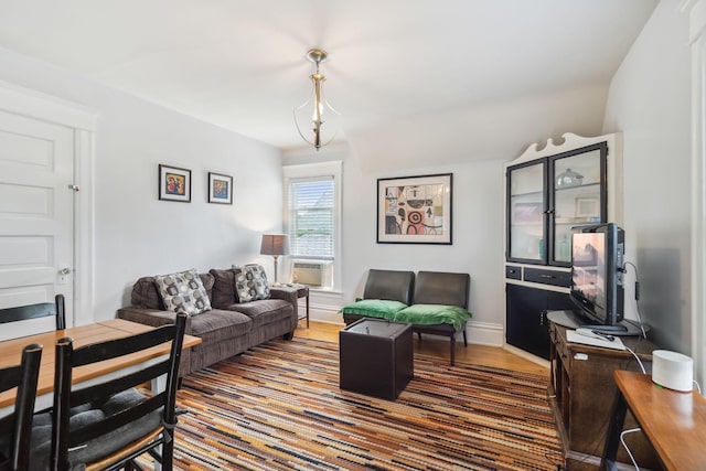 3304 Longfellow Ave, Minneapolis, MN 55407 - living area featuring wood finished floors, cooling unit, and baseboards