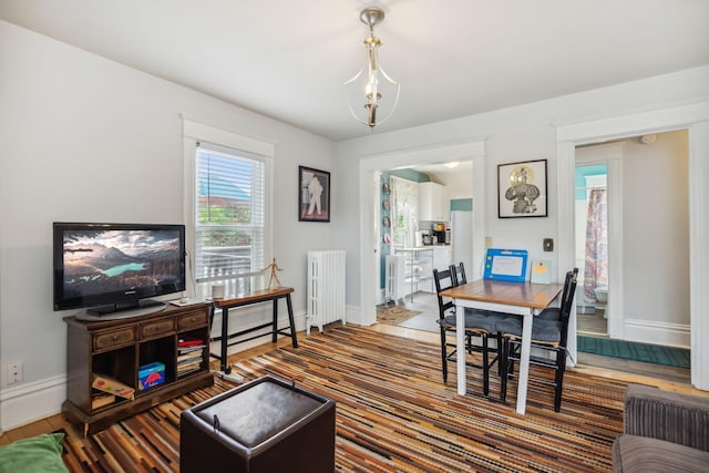 3304 Longfellow Ave, Minneapolis, MN 55407 - living area with baseboards, radiator heating unit, and wood finished floors