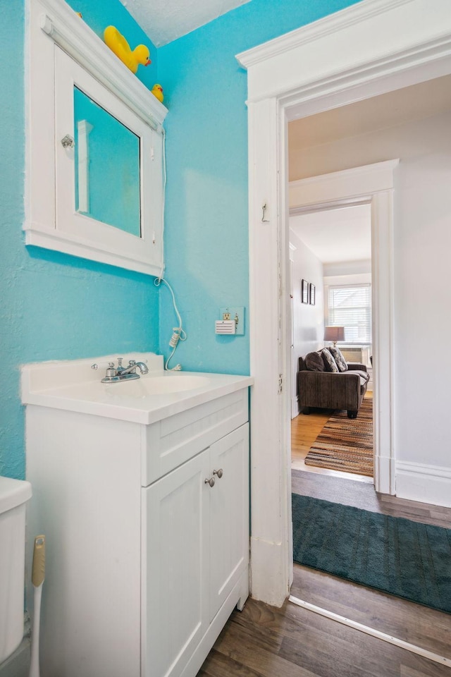3304 Longfellow Ave, Minneapolis, MN 55407 - half bathroom featuring wood finished floors and vanity
