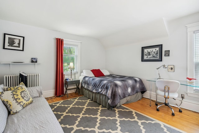 3304 Longfellow Ave, Minneapolis, MN 55407 - bedroom with radiator heating unit, vaulted ceiling, wood finished floors, and baseboards
