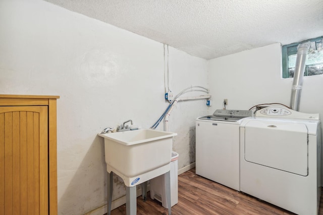 3304 Longfellow Ave, Minneapolis, MN 55407 - washroom featuring wood finished floors, laundry area, washer and dryer, a sink, and a textured ceiling