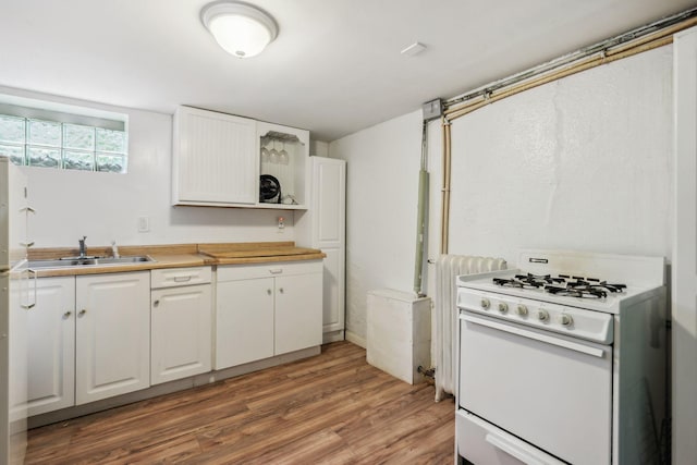 3304 Longfellow Ave, Minneapolis, MN 55407 - kitchen with white cabinetry, a sink, light countertops, gas range gas stove, and light wood finished floors
