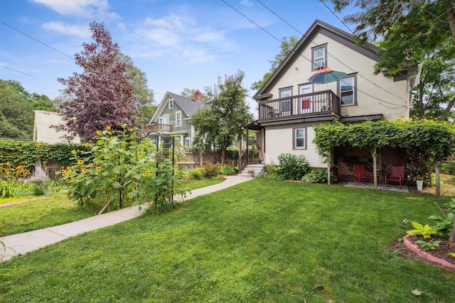 3304 Longfellow Ave, Minneapolis, MN 55407 - view of front facade featuring a front lawn, stucco siding, and a balcony