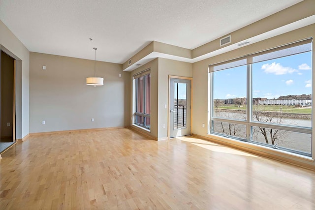 240 Spring St Unit 413, Saint Paul, MN 55102 - spare room featuring light wood-style flooring and baseboards