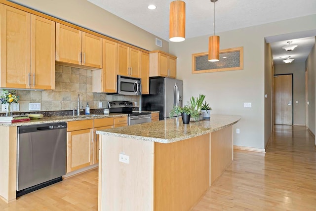 240 Spring St Unit 413, Saint Paul, MN 55102 - kitchen featuring stainless steel appliances, backsplash, light brown cabinets, and light wood-type flooring