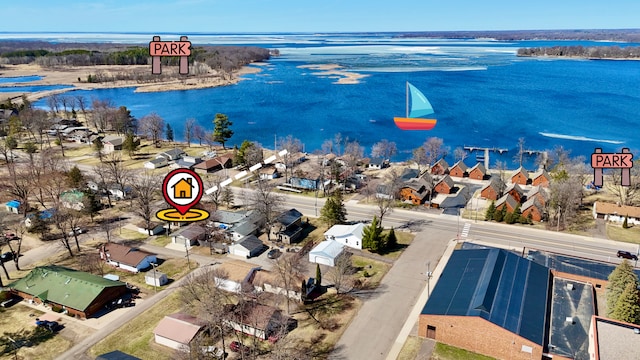 aerial view of residential area featuring a large body of water