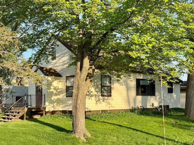 rear view of property featuring a yard