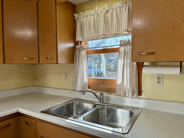kitchen featuring a sink and light countertops