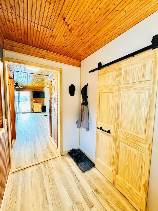41820 Bald Eagle Dr, Marcell Twp, MN 56628 - corridor with a barn door, wood finished floors, and wooden ceiling