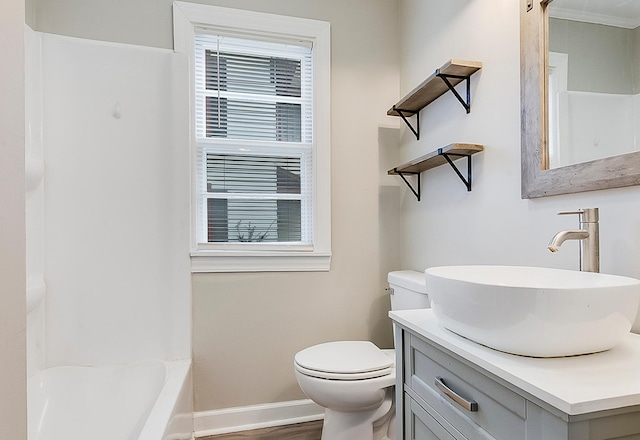 423 1st St NW, Faribault, MN 55021 - bathroom with toilet, baseboards, vanity, and wood finished floors