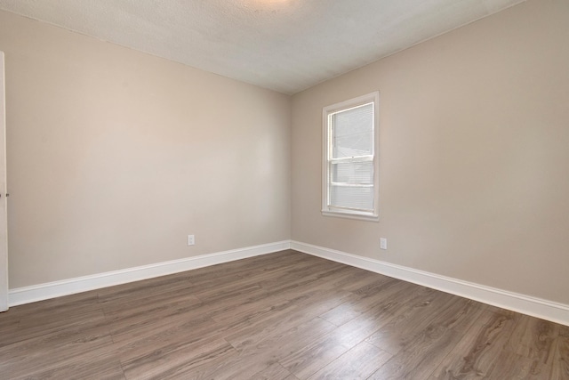 423 1st St NW, Faribault, MN 55021 - unfurnished room featuring dark wood finished floors and baseboards