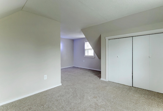 423 1st St NW, Faribault, MN 55021 - additional living space with carpet flooring, baseboards, and vaulted ceiling