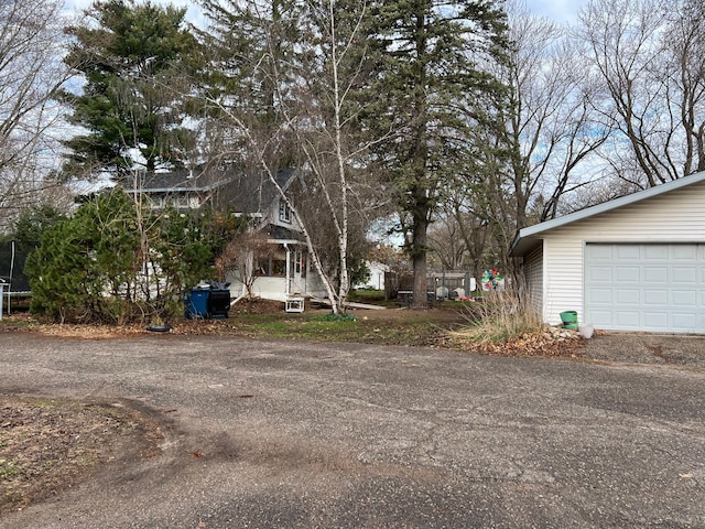 view of yard with a garage and a trampoline