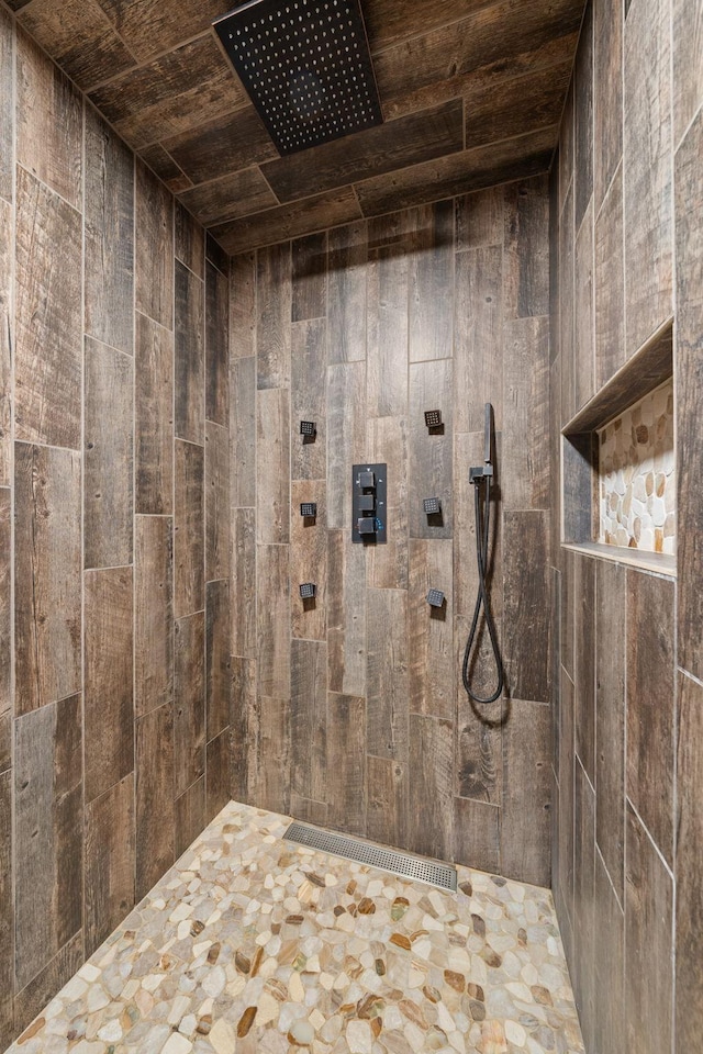 bathroom featuring wooden ceiling and tiled shower