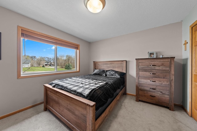 bedroom with light carpet and baseboards