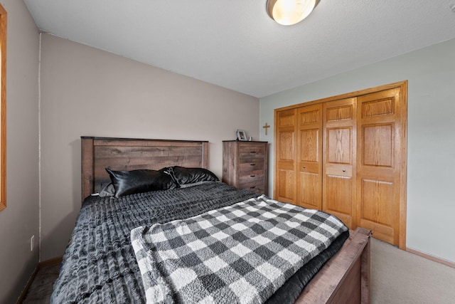 bedroom with baseboards, carpet floors, and a closet