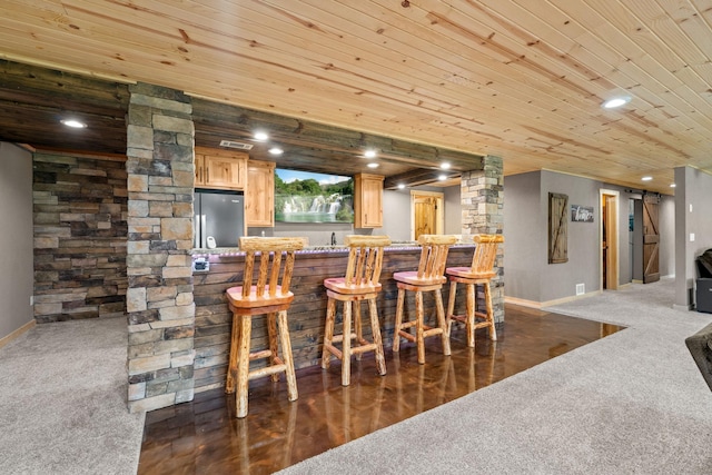 indoor bar with freestanding refrigerator, dark colored carpet, baseboards, wood ceiling, and recessed lighting