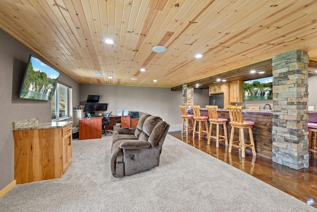 living area with bar with sink, recessed lighting, wood ceiling, wood finished floors, and ornate columns
