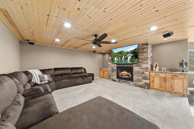 carpeted living area with wooden ceiling, recessed lighting, ceiling fan, a fireplace, and baseboards