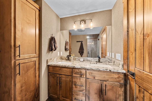 bathroom with a textured wall and double vanity